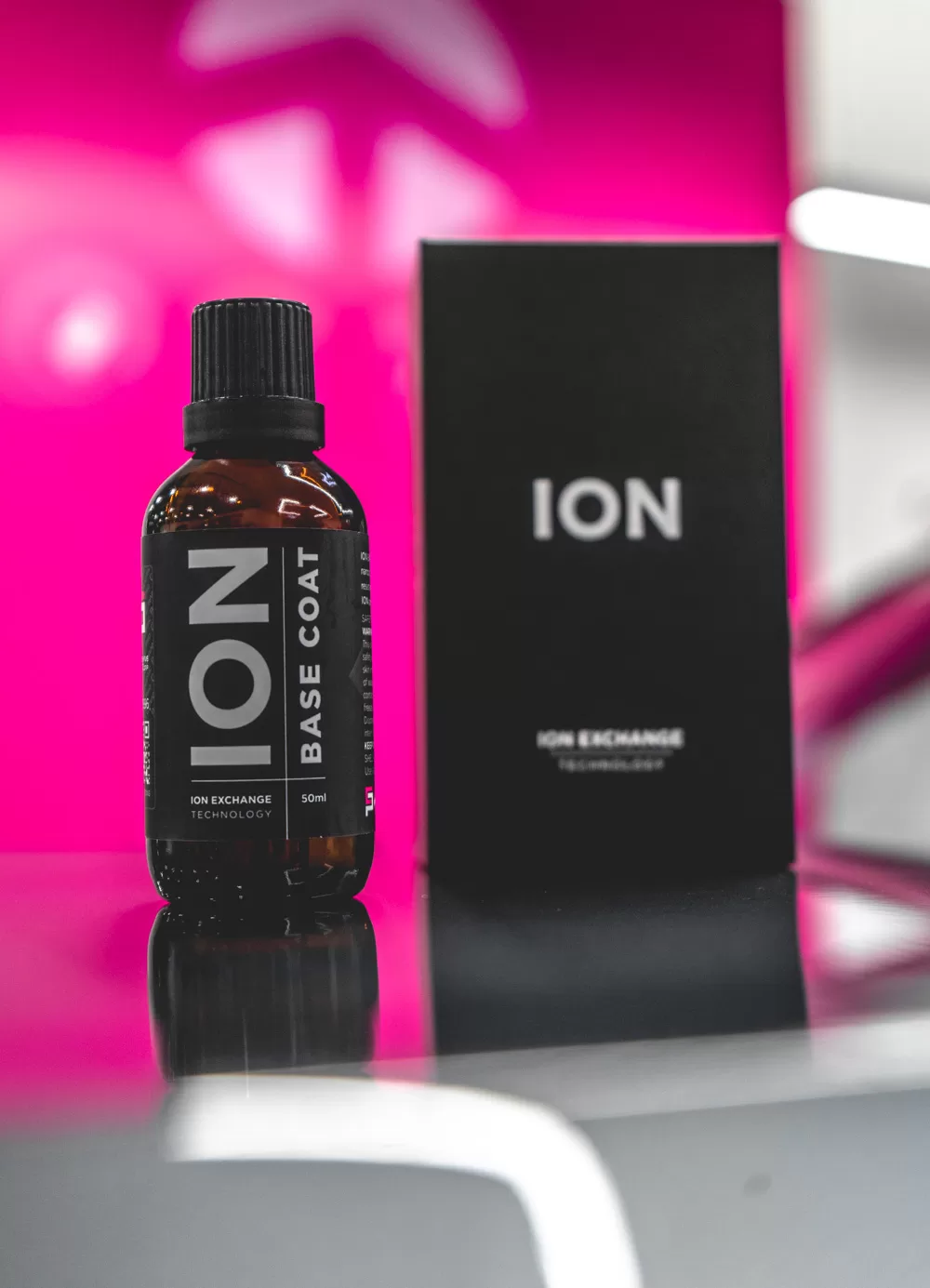 A bottle of ion base coat next to its box.
